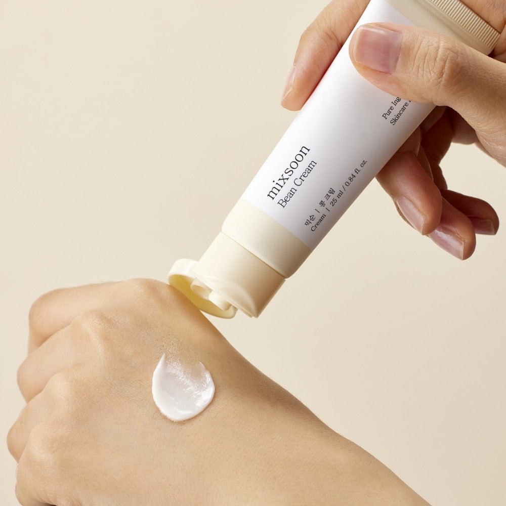 MIXSOON Bean Cream 25ml being applied to hand, showcasing texture and packaging.