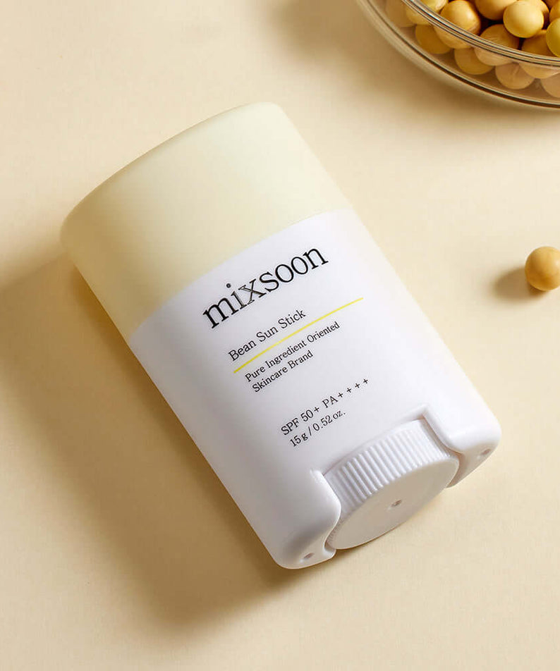 MIXSOON Bean Sun Stick with SPF 50+, featuring natural ingredients for sun protection, displayed on a beige background with beans.