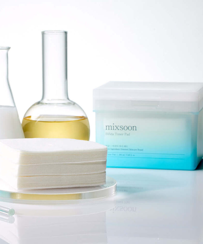 MIXSOON Bifida Toner Pad next to laboratory glassware for skincare routine