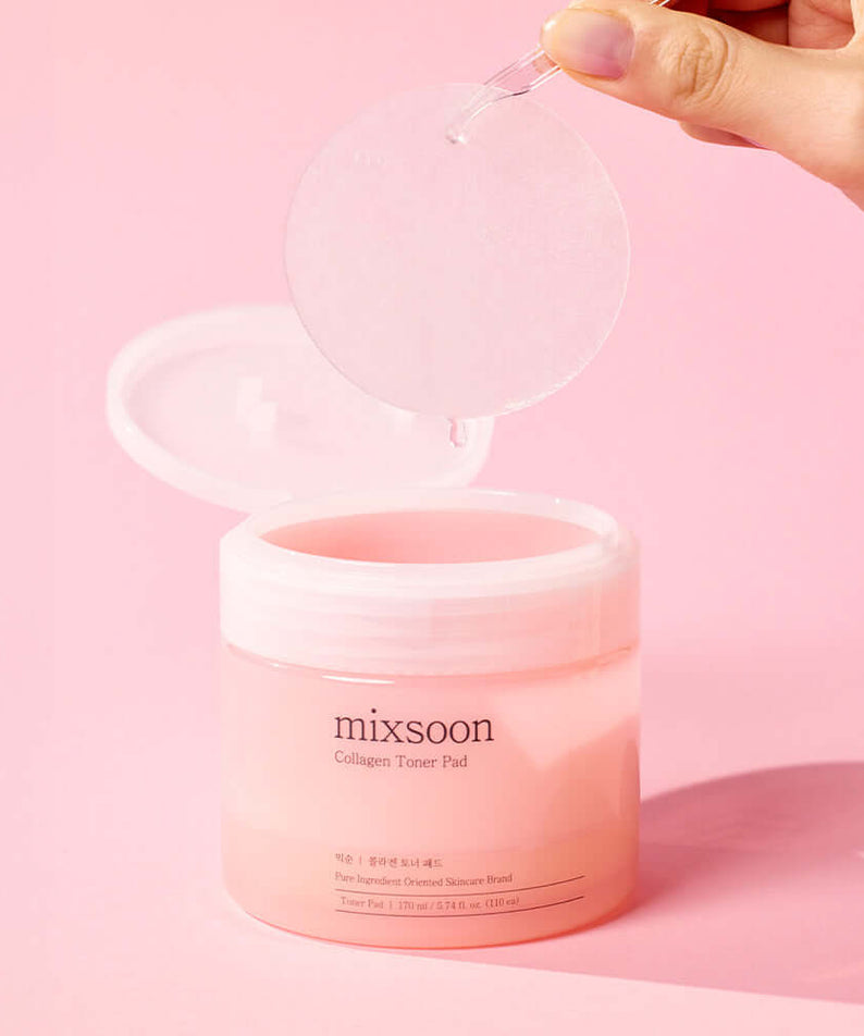 MIXSOON Collagen Toner Pad being held above a pink jar on a pink background
