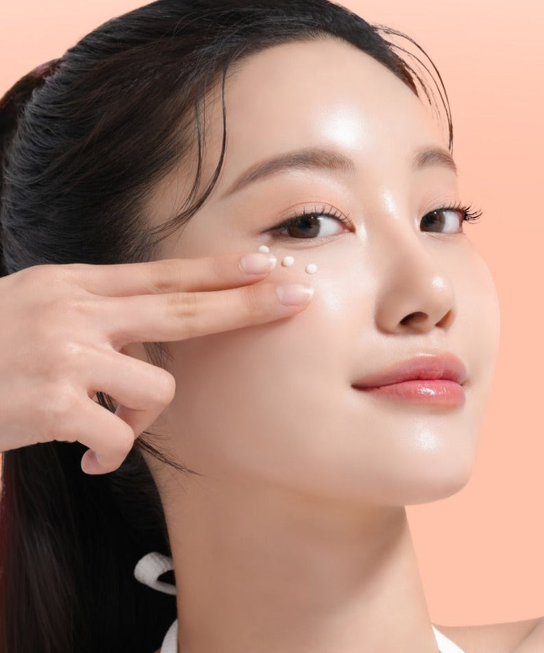 Woman applying MIXSOON PDRN Collagen Eye Serum 20ml around eyes on clear skin