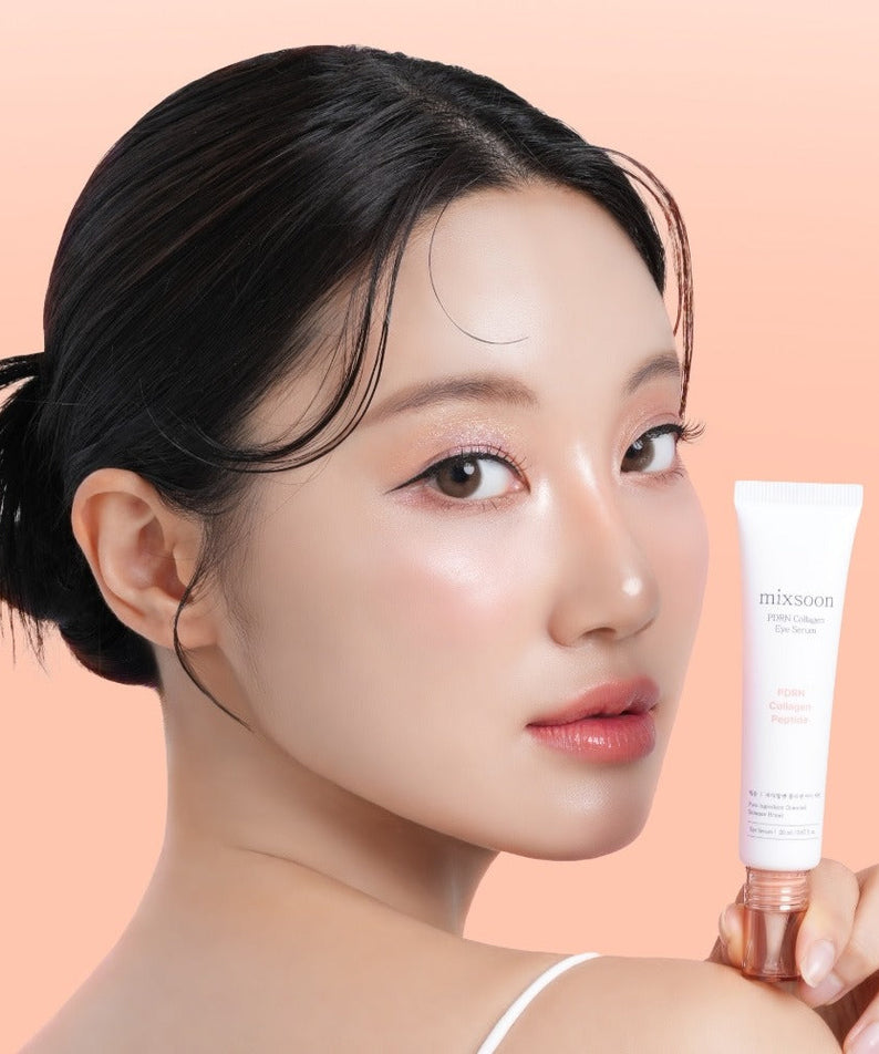 Woman holding MIXSOON PDRN Collagen Eye Serum 20ml against a peach background