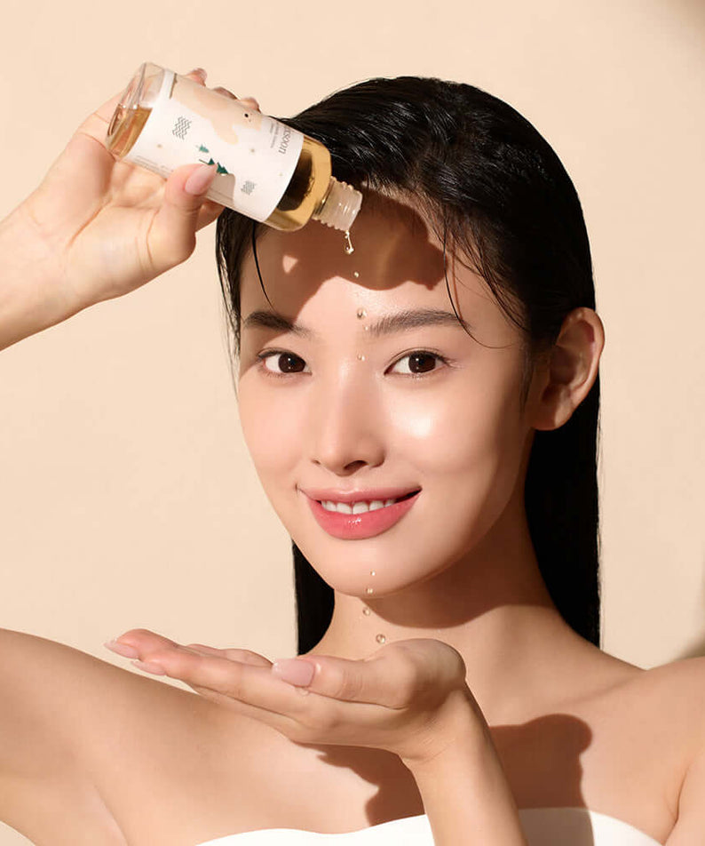 Woman applying MIXSOON Soondy Centella Asiatica Essence 100ml to face, highlighting skincare routine