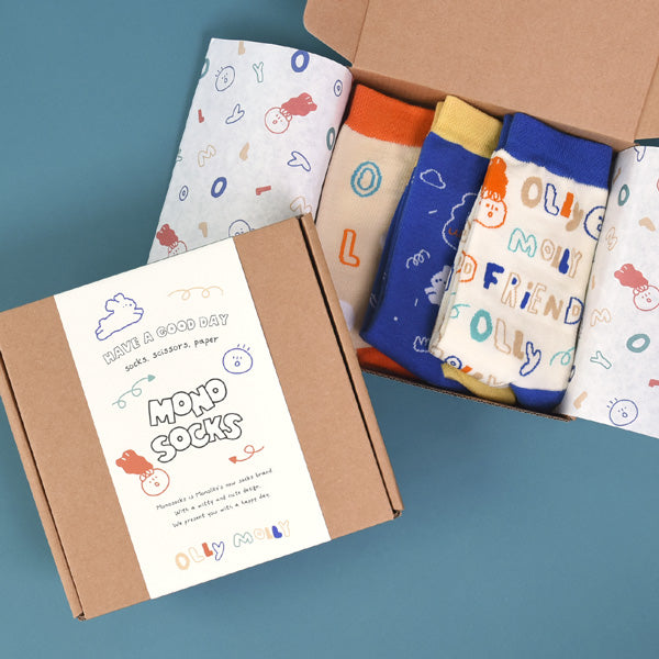MONOLIKE Olly Molly - Pattern Set featuring colorful socks in a gift box on a blue background.