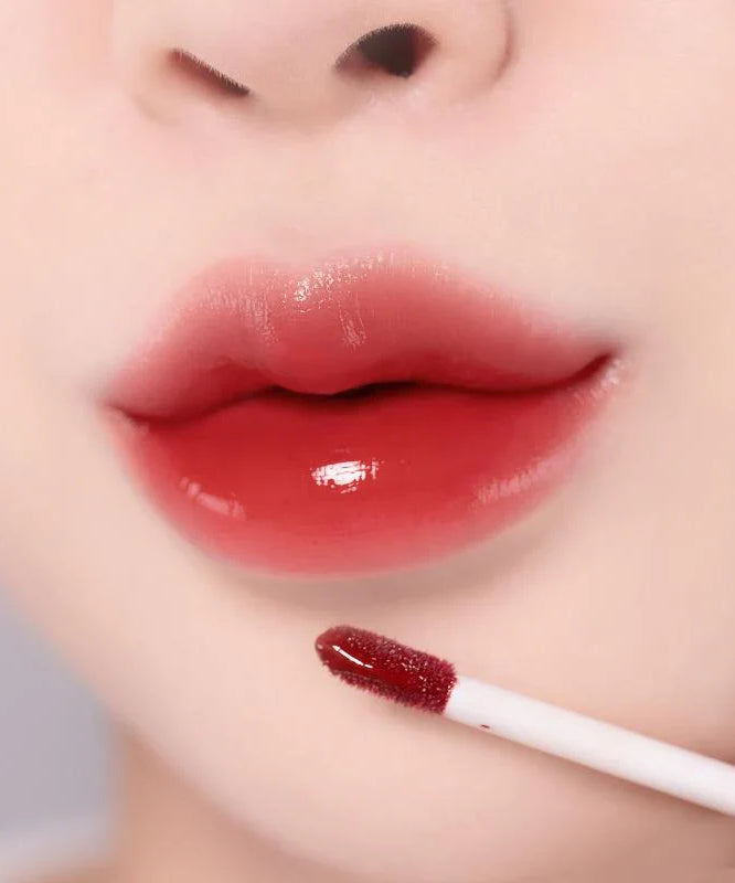 Close-up of lips wearing MOOLDA Glow Dewy Tint, showcasing glossy red tint application.