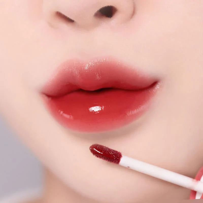 Close-up of lips wearing MOOLDA Glow Dewy Tint, showcasing glossy red tint application.