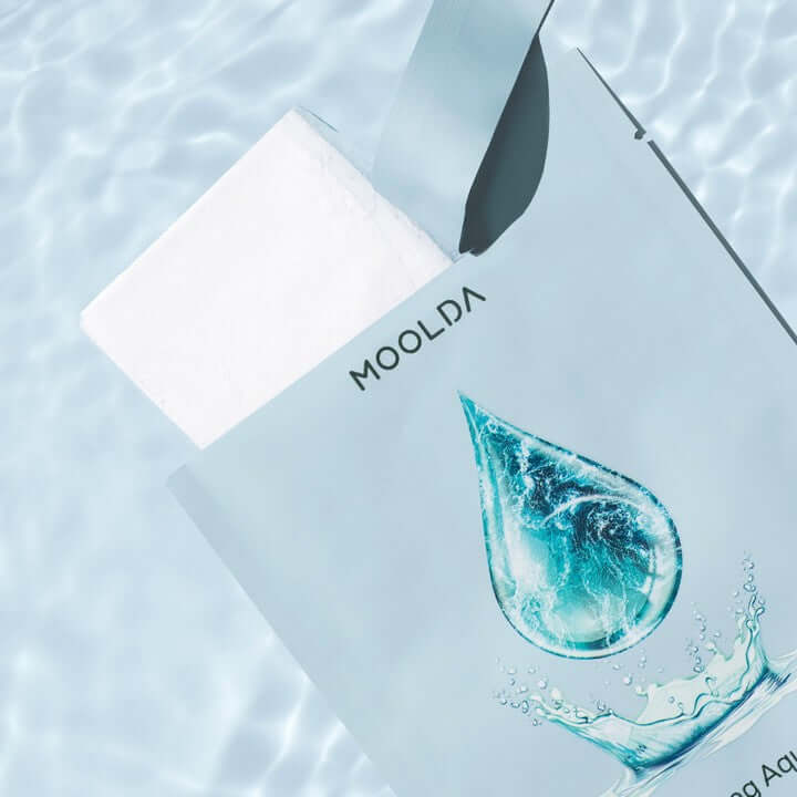 MOOLDA Moisturizing Aqua Mask package with water droplet design on a light blue background.