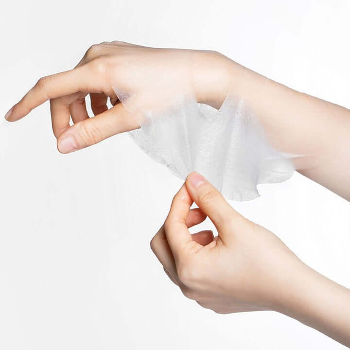 Applying MOOLDA Moisturizing Aqua Mask sheet on hand for hydration and skin nourishment.