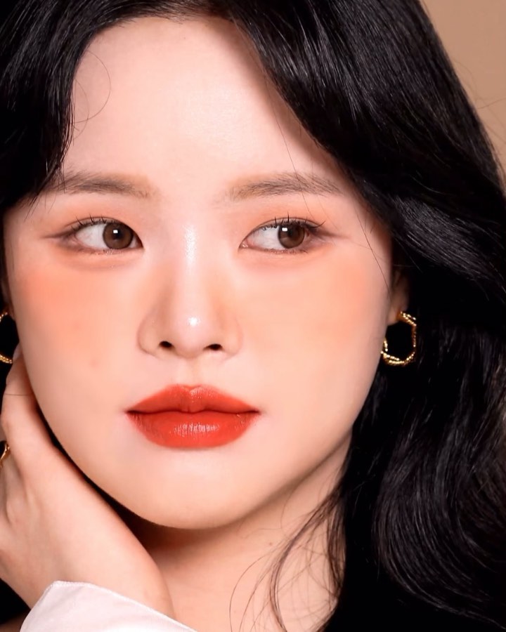 Model wearing MOOLDA Tattoo Fixing Lip Tint with vibrant red lips, showcasing flawless application and long-lasting color.