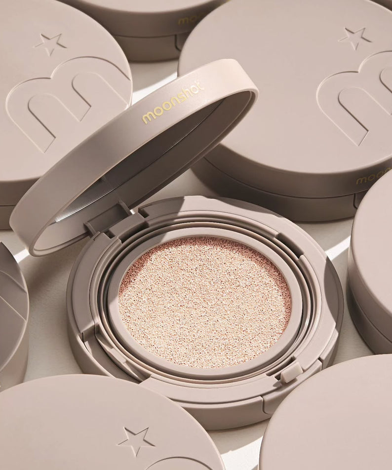 MOONSHOT Conscious Fit Cushion Foundation in open compact with soft beige lid, highlighting smooth cushion texture and sleek design.