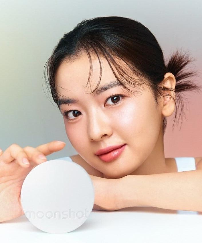 Woman holding MOONSHOT Conscious Fit Glow Cushion Foundation with radiant skin