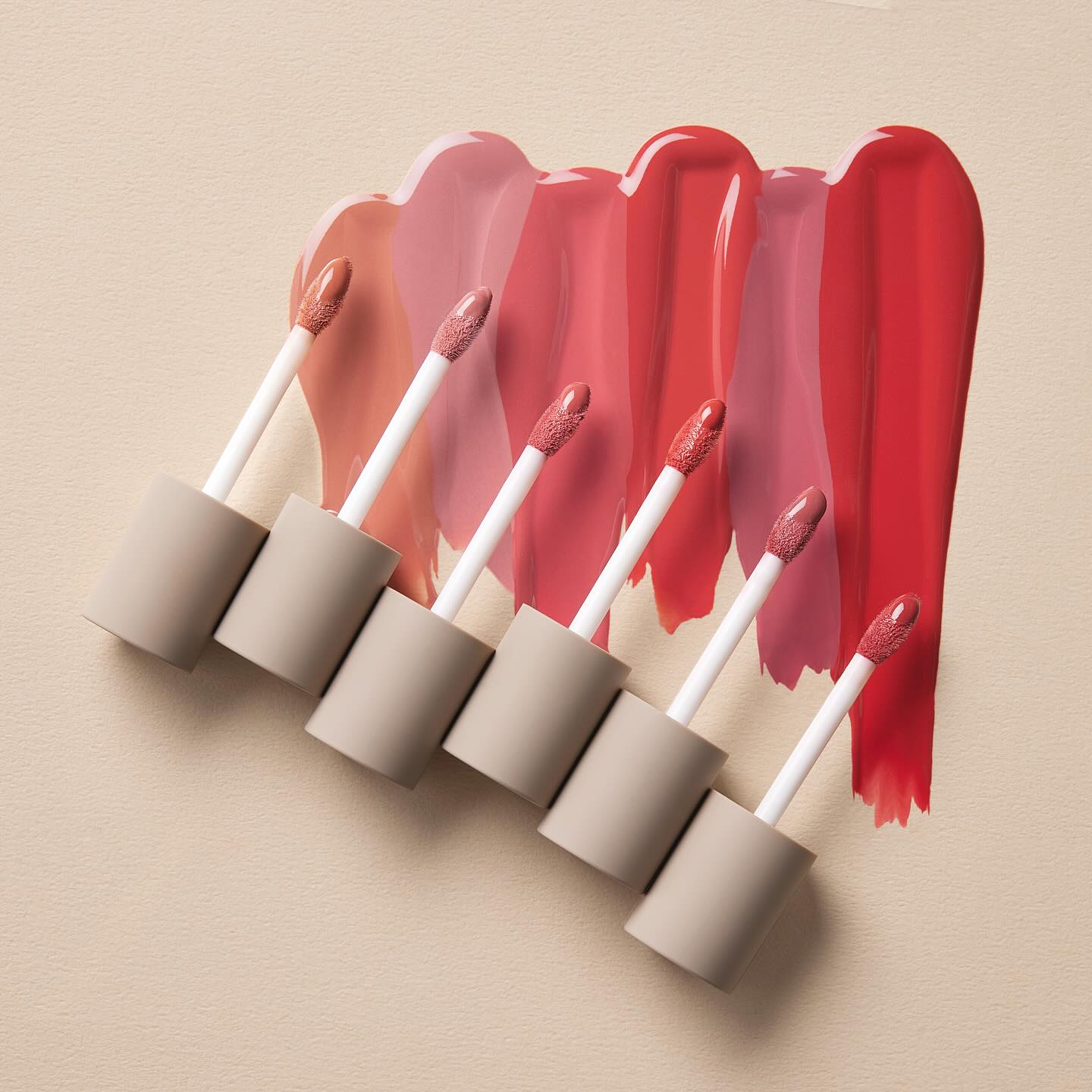 MOONSHOT Conscious Fit Melow Lip Tint in various shades with applicator wands on a neutral background