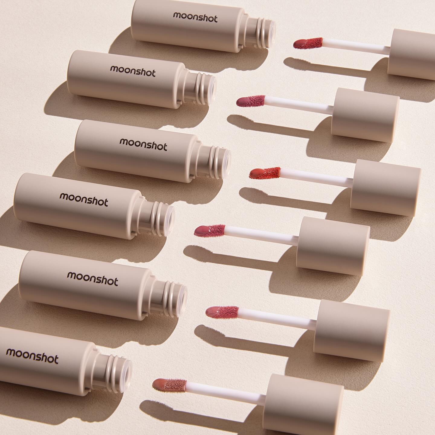 MOONSHOT Conscious Fit Melow Lip Tint tubes displayed with applicators.