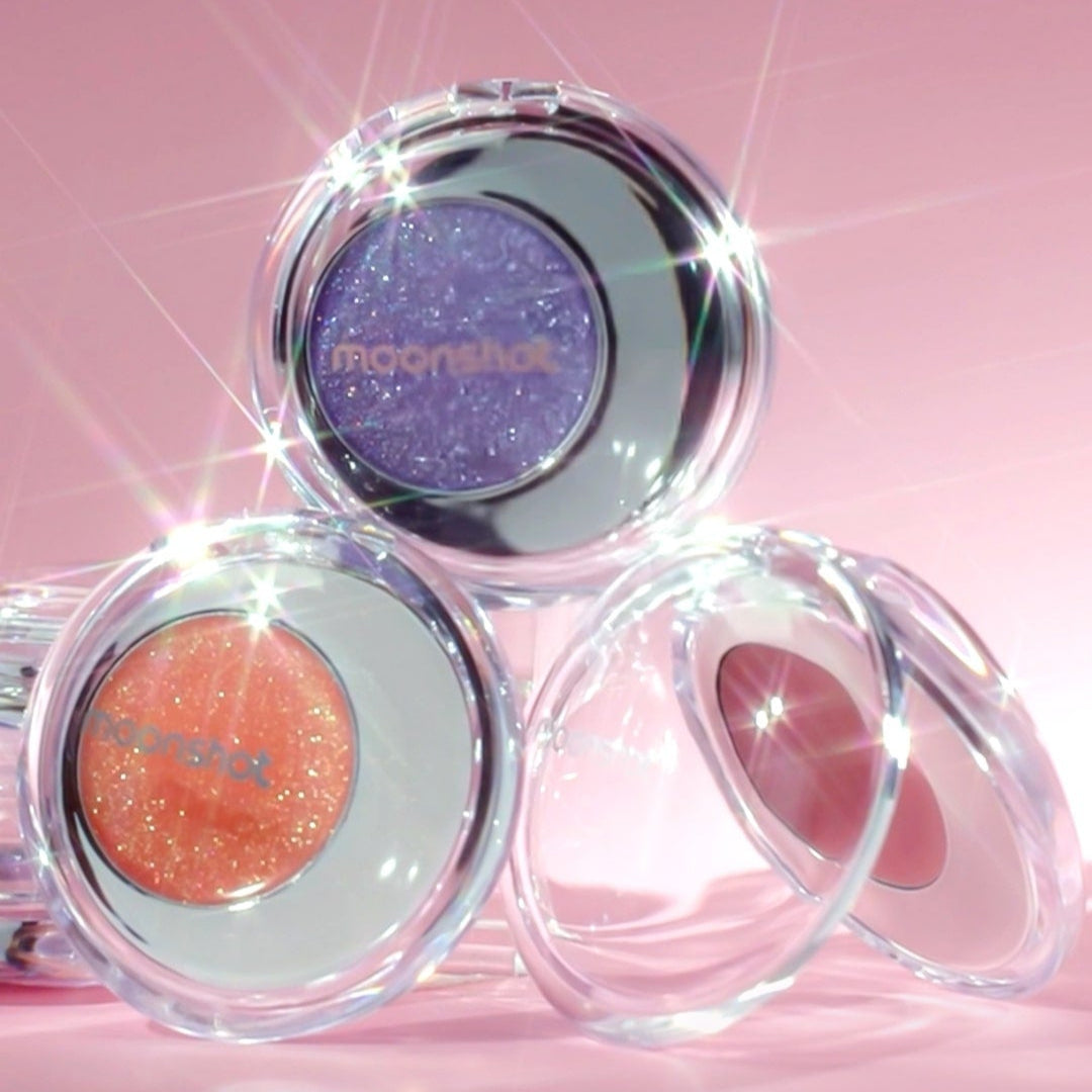 MOONSHOT Melting Mood Lip & Cheek products showcase with vibrant colors and sparkle against a pink background.