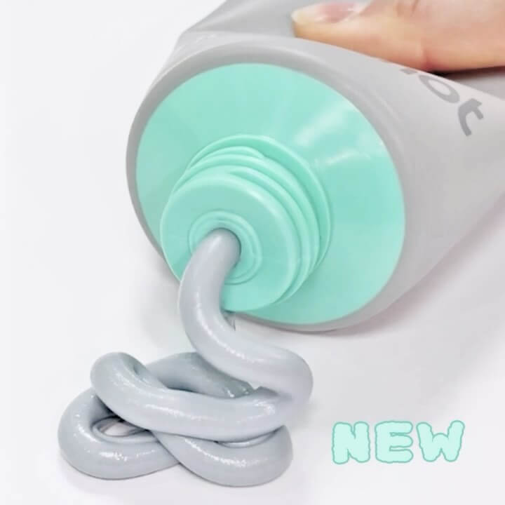 MOONSHOT Micro Black Cleansing Foam being dispensed from a light grey tube. Suitable for deep cleansing and skincare. New product.