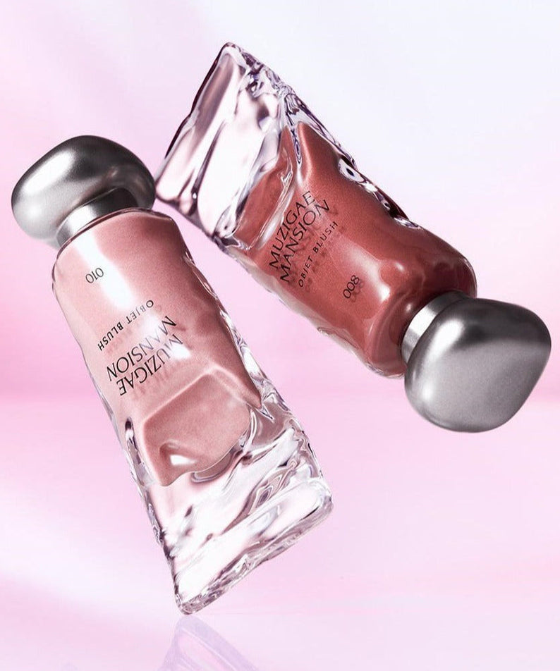 MUZIGAE MANSION Object Blush 5ml floating in artistic glass bottles against a soft pink background, highlighting luxury beauty product