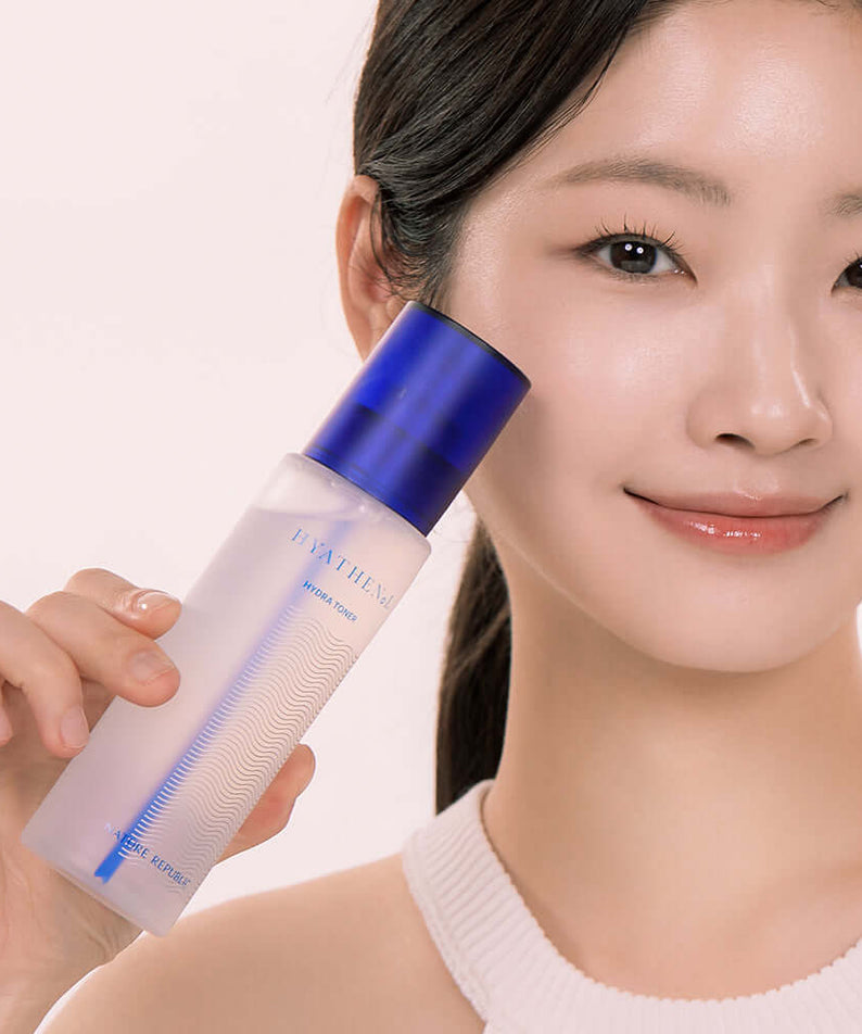 Person holding NATURE REPUBLIC Hyathenol Hydra Toner 150ml bottle with blue cap