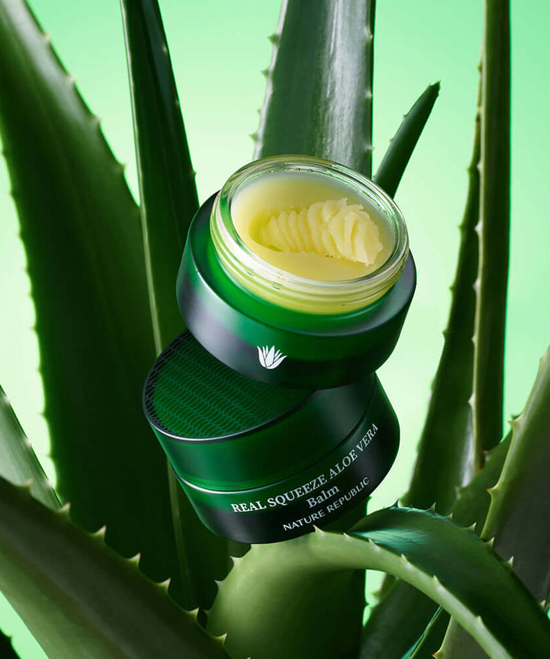 NATURE REPUBLIC Real Squeeze ALoe Vera Balm 25g displayed among aloe vera leaves