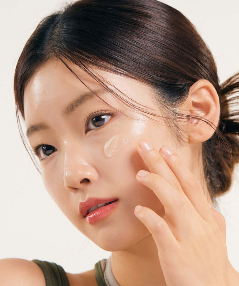 Model applying NATURE REPUBLIC Real Squeeze Aloe Vera Cream 55ml to her face for hydrated skin routine