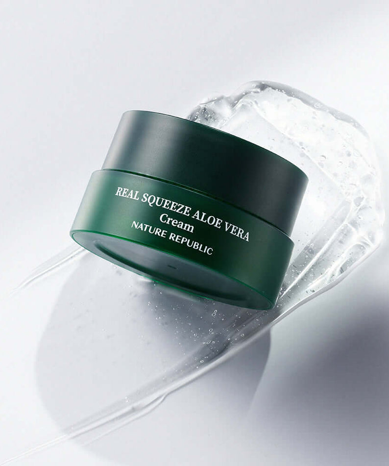 NATURE REPUBLIC Real Squeeze Aloe Vera Cream 55ml jar on a smooth surface with aloe vera gel, highlighting skincare product.