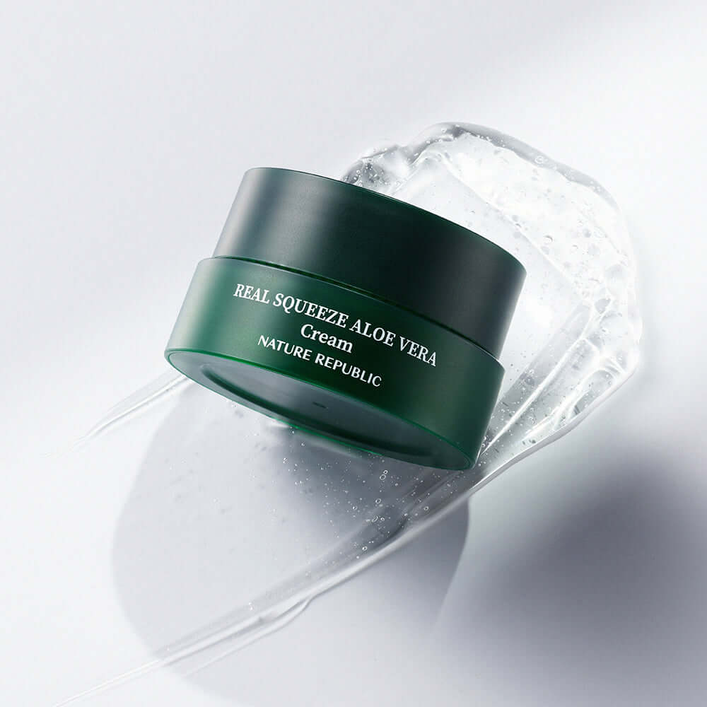 NATURE REPUBLIC Real Squeeze Aloe Vera Cream 55ml jar on a smooth surface with aloe vera gel, highlighting skincare product.