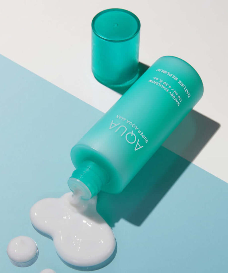 NATURE REPUBLIC Super Aqua Max Watery Emulsion 130ml bottle spilling on blue surface