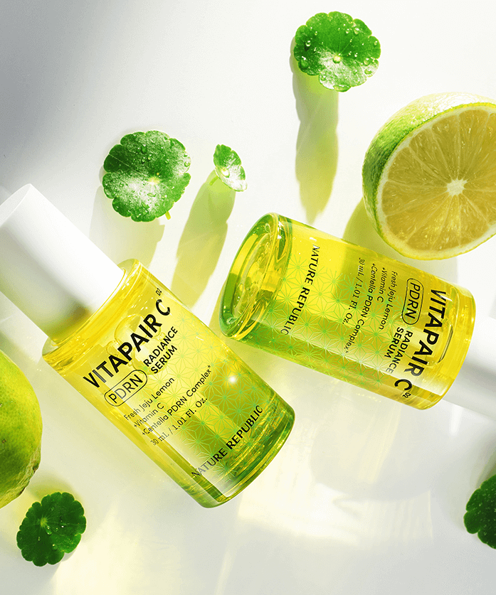 NATURE REPUBLIC Vitapair C PDRN Radiance Serum 30ml bottles with citrus and leaves on white background, highlighting skincare benefits