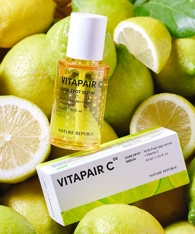 NATURE REPUBLIC Vitapair C SPot Serum 45ml bottle and packaging surrounded by fresh lemons