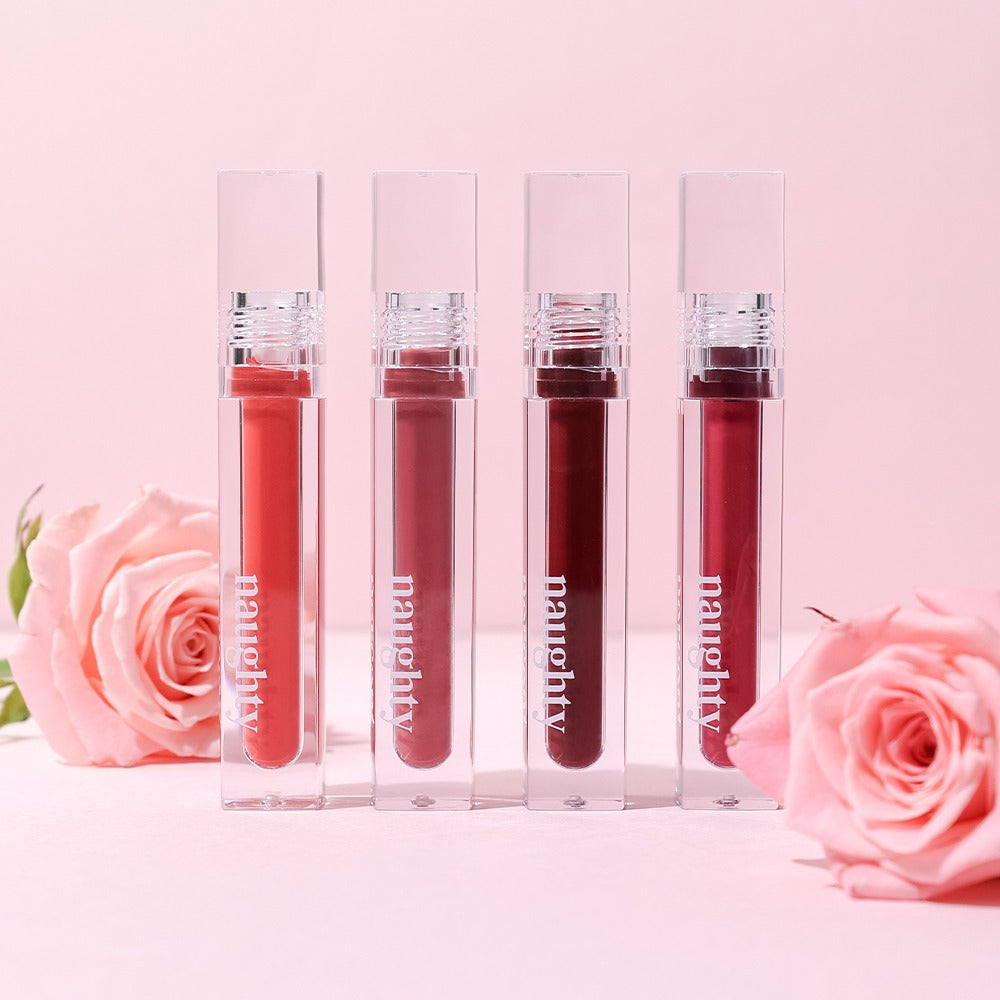 NAUGHTY PERCENT Matte Bloom Tint lipsticks with pink roses on a pastel pink background