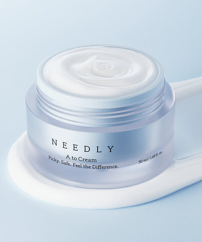 NEEDLY A to Cream 50ml moisturizing jar on blue background