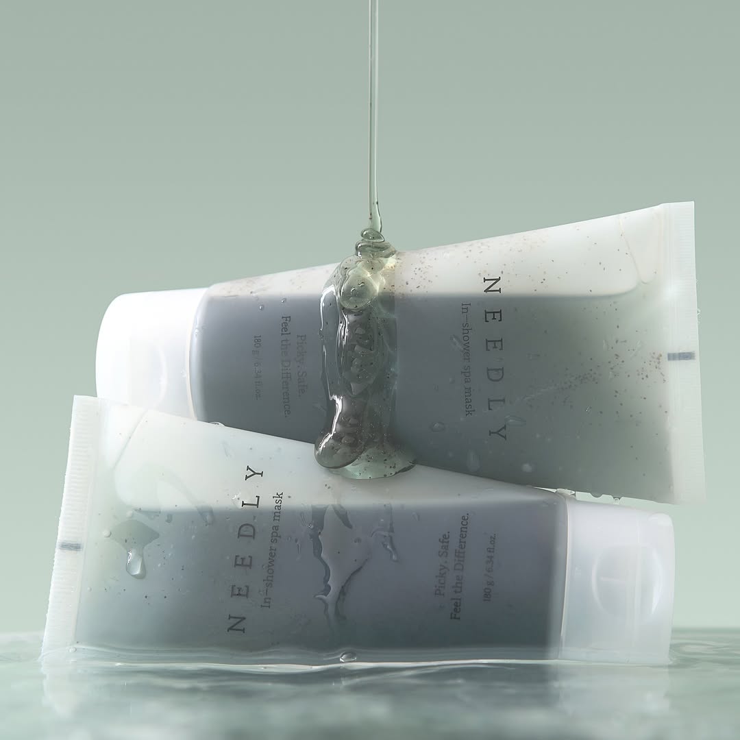 Two tubes of NEEDLY Ishower Spa Mask 180g with water droplets, showcasing moisturizing spa treatment.