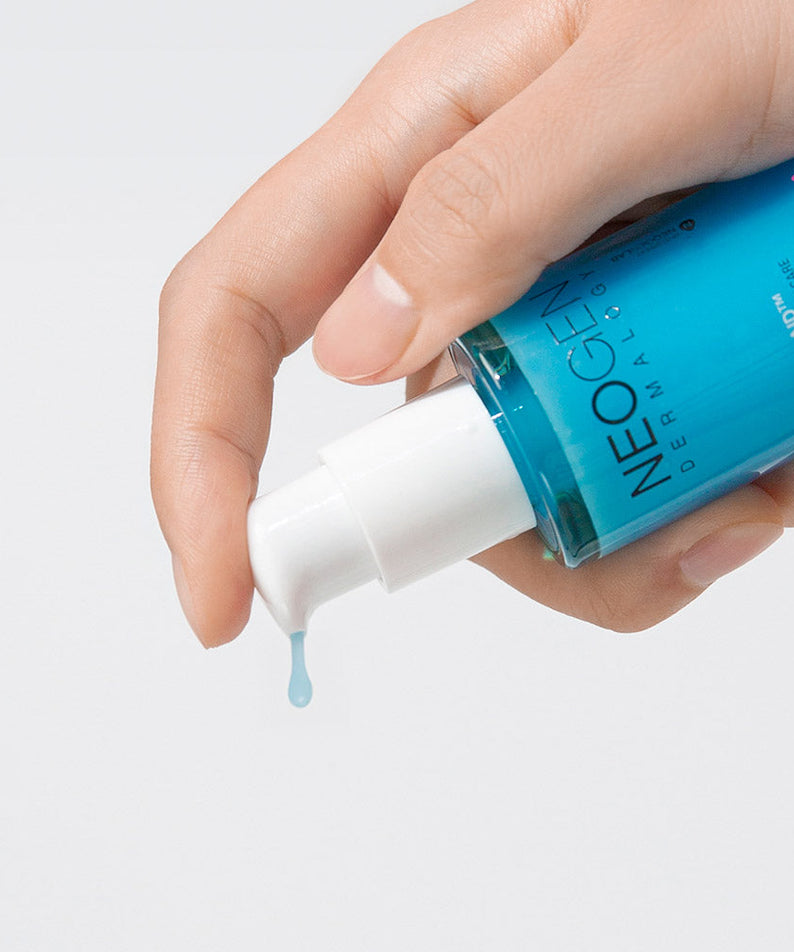 NEOGEN A Clear Serum 30ml being dispensed from a bottle onto a hand, showcasing texture and packaging.