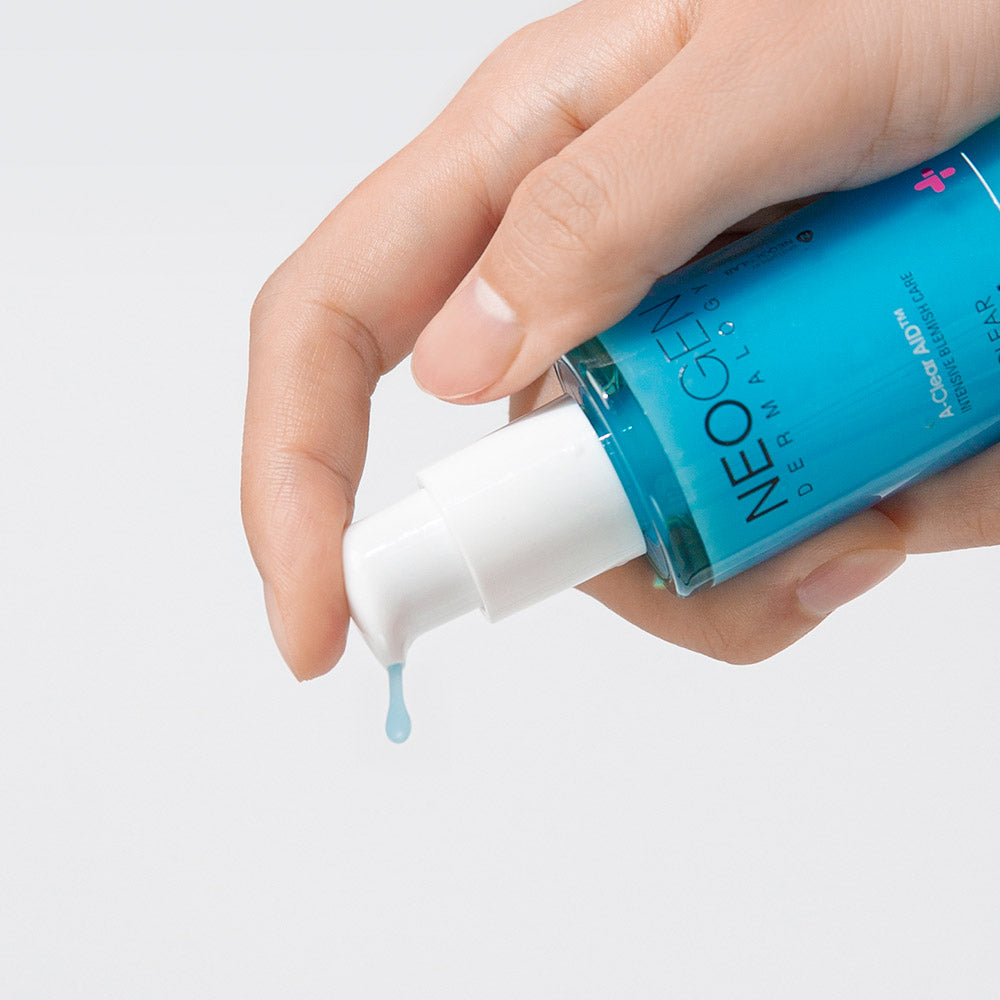 NEOGEN A Clear Serum 30ml being dispensed from a bottle onto a hand, showcasing texture and packaging.