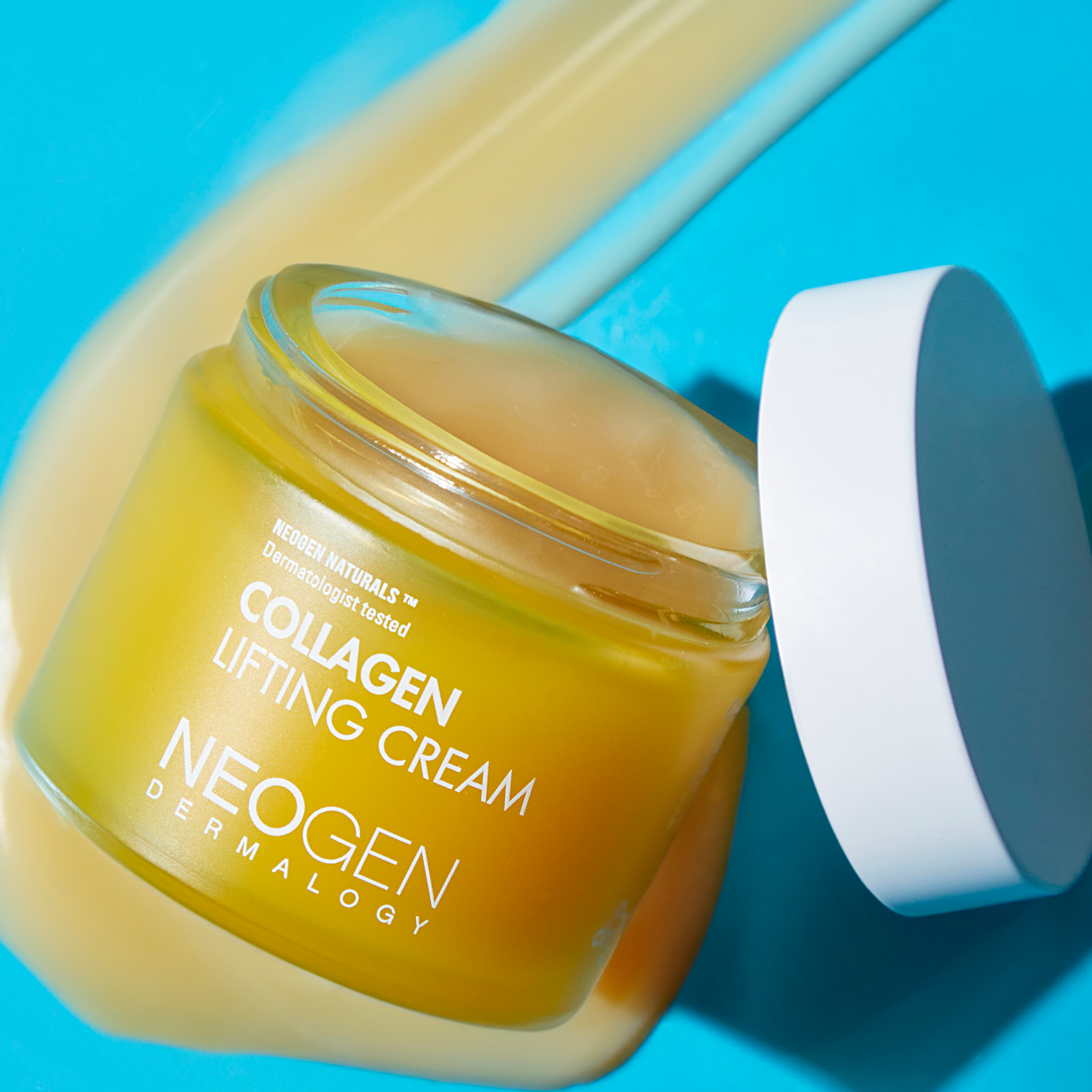 NEOGEN Collagen Lifting Cream 70ml jar with open lid on a blue background