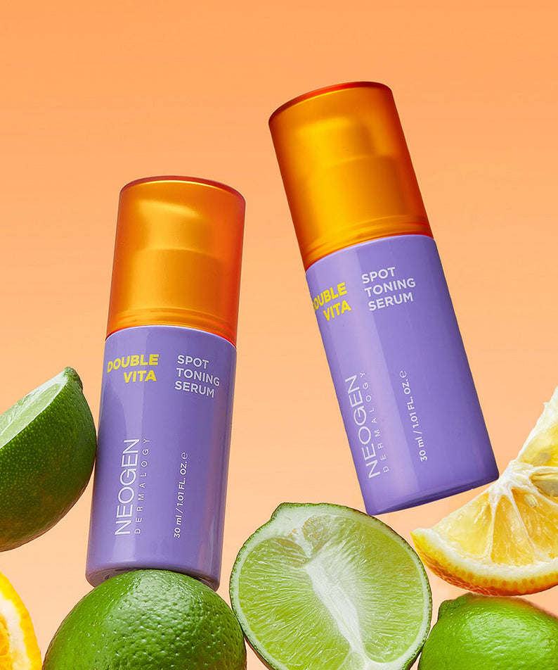NEOGEN Double Vita Spot Toning Serum 30ml with citrus fruits on an orange background