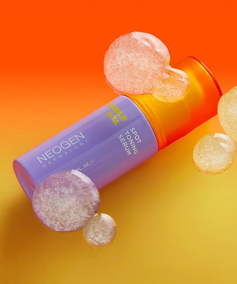 NEOGEN Double Vita Spot Toning Serum 30ml with vibrant bubbles and orange background