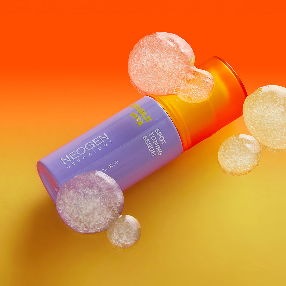 NEOGEN Double Vita Spot Toning Serum 30ml with vibrant bubbles and orange background