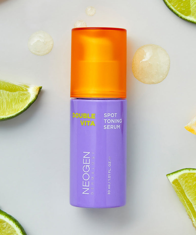NEOGEN Double Vita Spot Toning Serum 30ml surrounded by fresh citrus slices