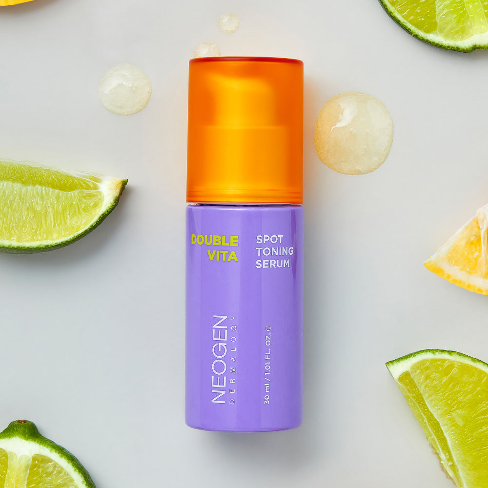 NEOGEN Double Vita Spot Toning Serum 30ml surrounded by fresh citrus slices