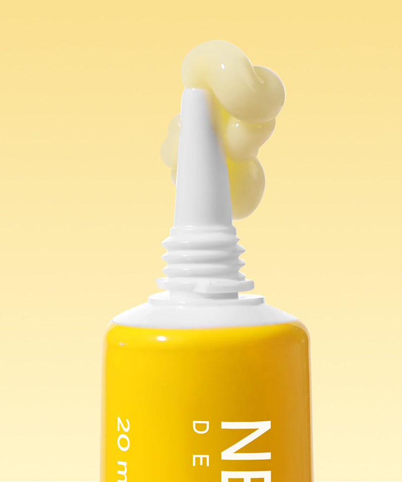 NEOGEN Next Clear Eye Cream 20ml tube with cream on nozzle against yellow background