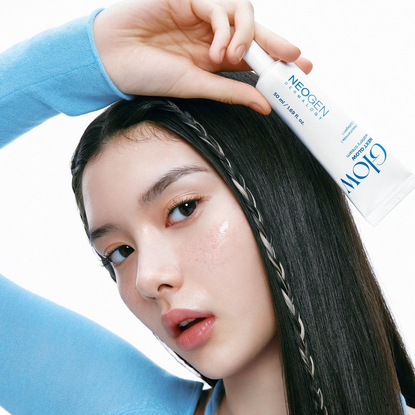 NEOGEN Next Glow 3-piece set (prep serum + moisture cream + pore refining toner) held by model for skincare demonstration.