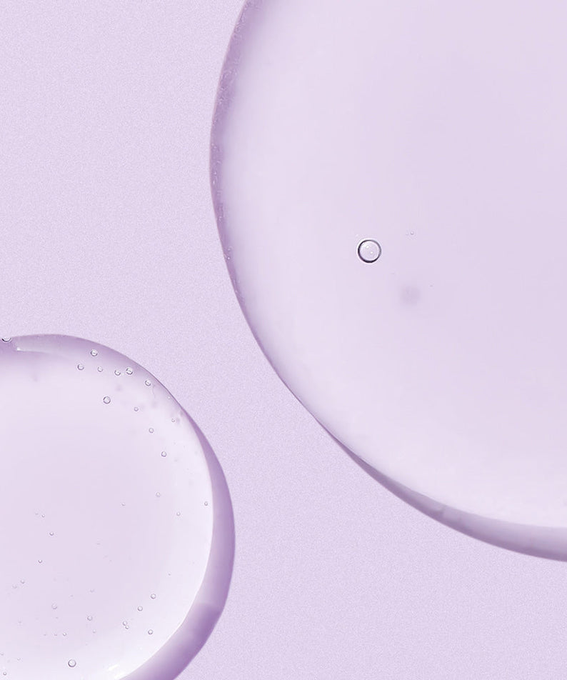 Texture of NEOGEN Real Bakuchiol Firming Serum 30ml on a lavender background