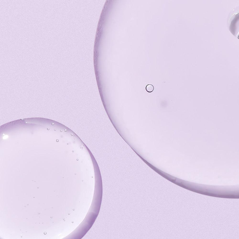 Texture of NEOGEN Real Bakuchiol Firming Serum 30ml on a lavender background