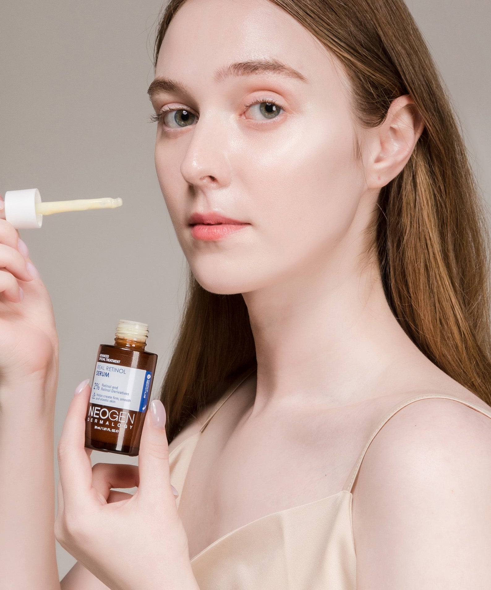 Woman applying NEOGEN Real Retinol Serum 30ml to her face