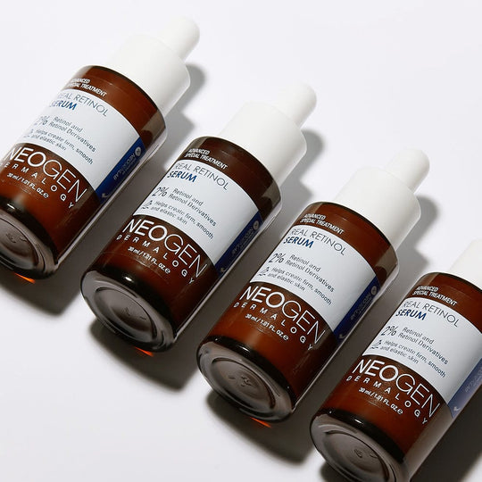 Four bottles of NEOGEN Real Retinol Serum 30ml displayed on a white background.