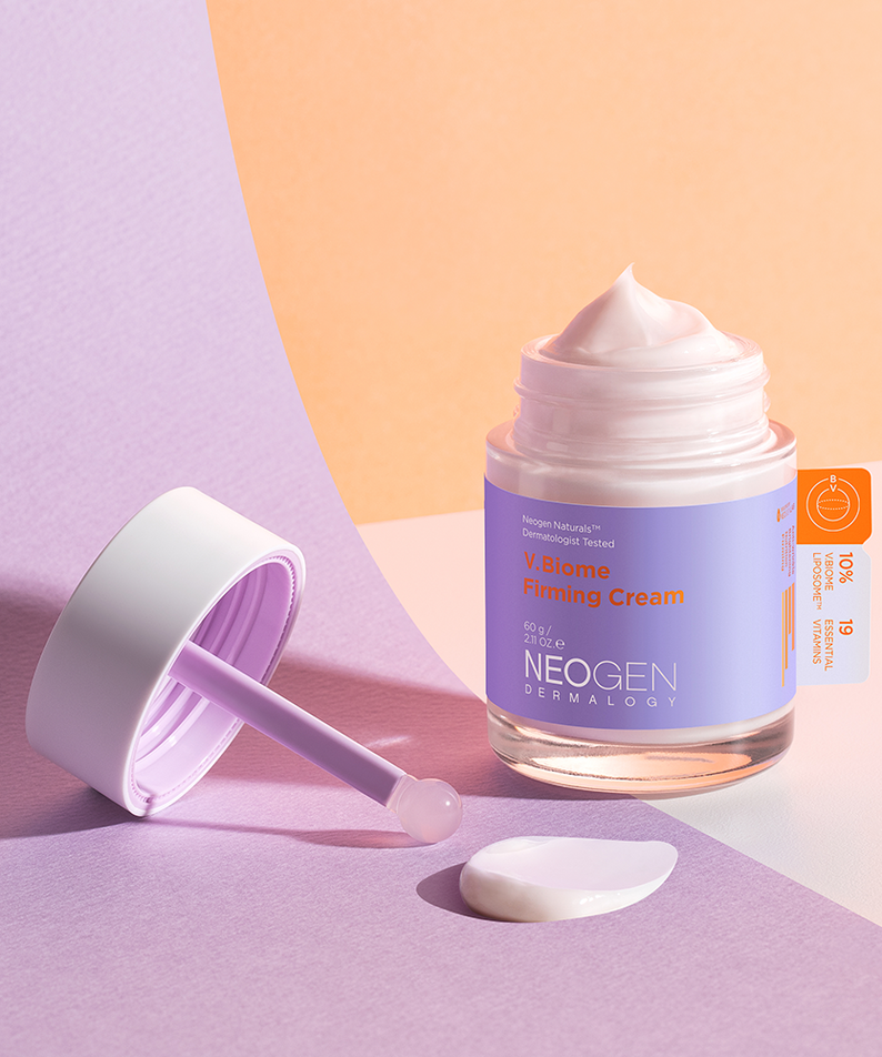 Jar of NEOGEN V Biome Firming Cream 60g on a pastel background with cream texture and spatula.