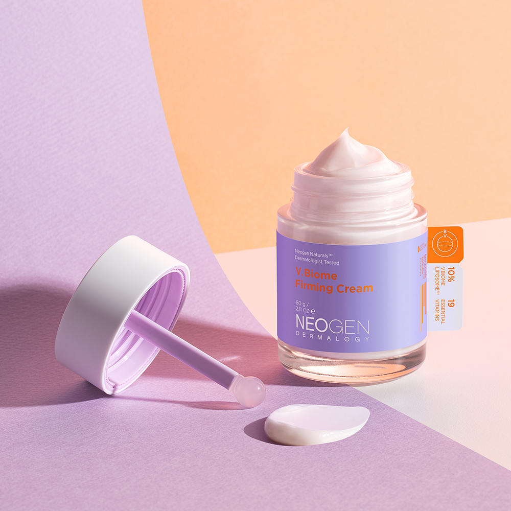 Jar of NEOGEN V Biome Firming Cream 60g on a pastel background with cream texture and spatula.