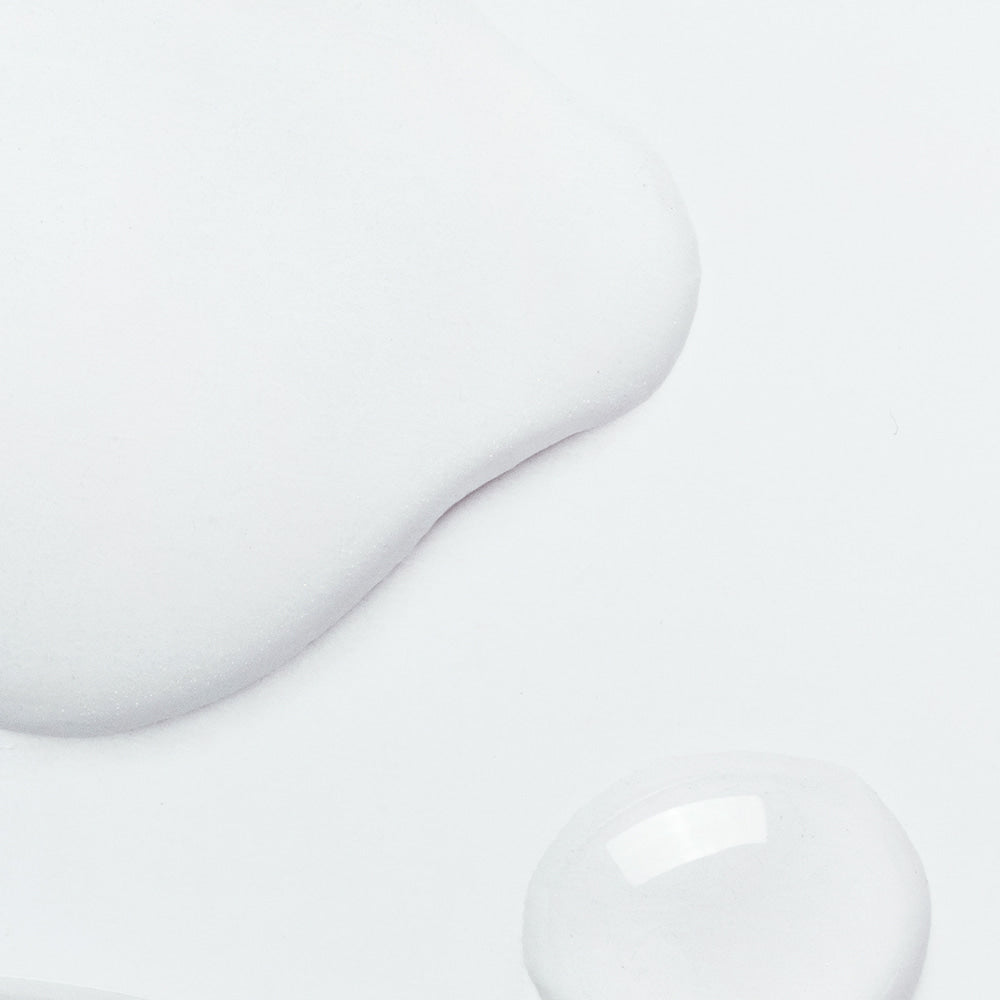 Texture of NEOGEN V Biome Infusion Serum 30ml on a white background, showcasing its smooth and hydrating qualities.