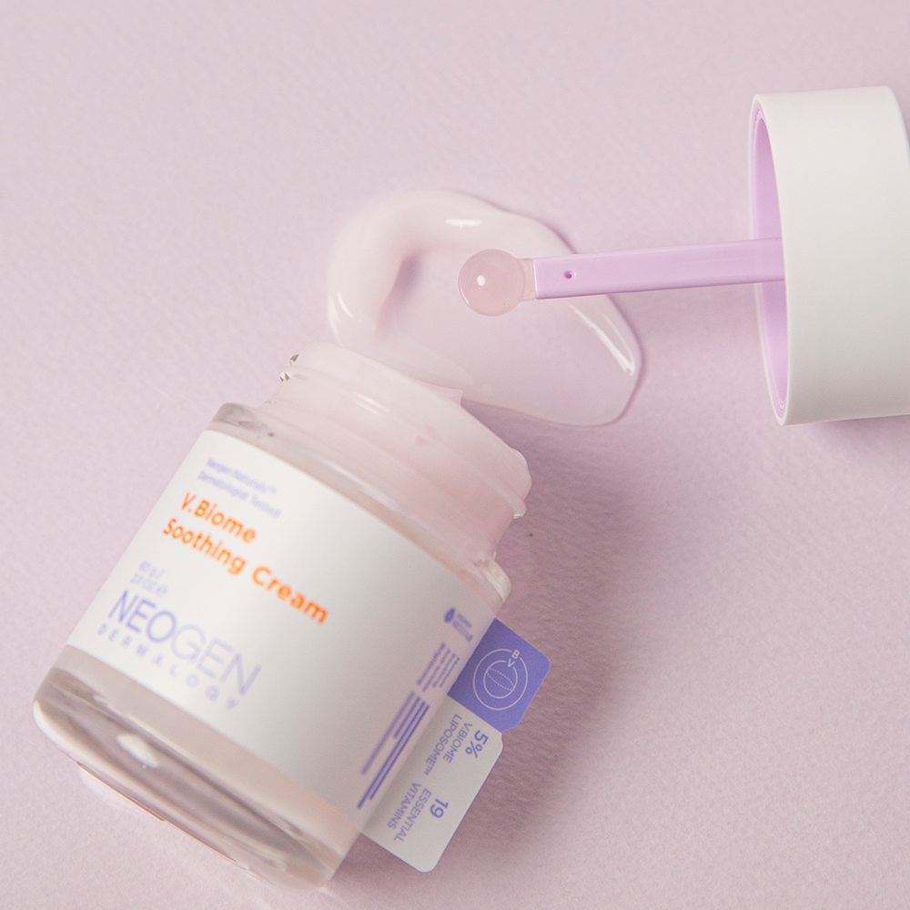 Jar of NEOGEN V Biome Soothing Cream 60g with scoop on pink background.