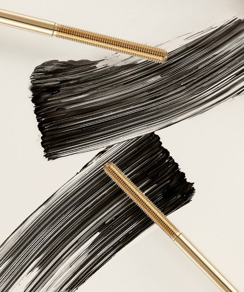 NEOGEN Volumizing Metal Mascara 4ml with brush strokes on a surface